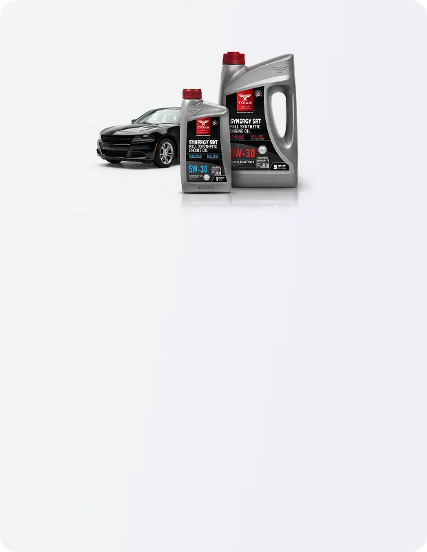 Two bottles of motor oil with a car in the background on a white background