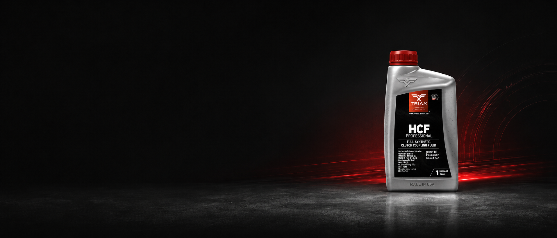 A bottle of HCF High Performance motor oil by Mobil 1 stands on a dark surface against a black background with red light streaks.