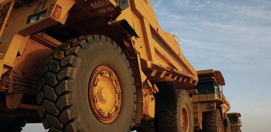 Large yellow mining truck with a clear sky background
